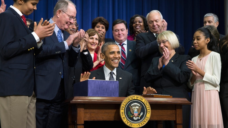 President Barack Obama signs S. 1177, Every Student Succeeds Act (ESSA), during a bill a signing ceremony in the Eisenhower Executive Office Building South Court Auditorium, Dec. 10, 2015. (photo credit: Evan Vucci/AP)